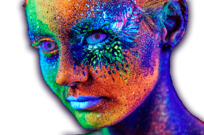 A performers face glowing brightly with uv paint
